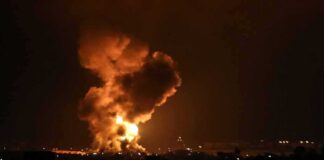Large explosion with fireball and smoke at night