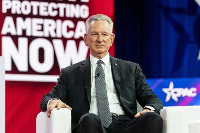 man in suit seated on stage during conference