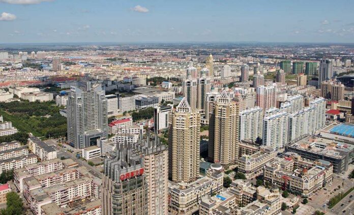 Aerial view of a sprawling urban city with high-rise buildings and green spaces