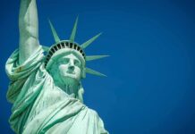 Statue of Liberty close-up against blue sky