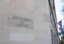 Department of Justice building exterior with American flags