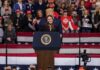 Donald Trump stands behind a speaker at a rally; Frank Wycheck and B. J. Daniels are present in the crowd