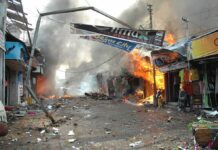 Street marketplace engulfed in fire and heavy smoke