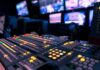 broadcast control room mixing console with illuminated buttons