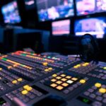 broadcast control room mixing console with illuminated buttons