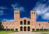 Brick collegiate building with twin towers and arched entrance