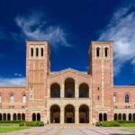 Brick collegiate building with twin towers and arched entrance