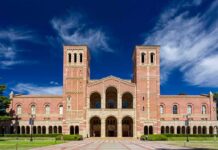 Brick collegiate building with twin towers and arched entrance