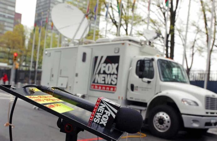 Fox News microphone and satellite truck on city street